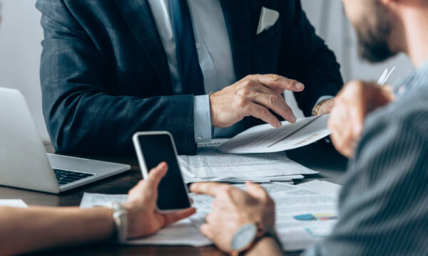 cropped view investor holding a document